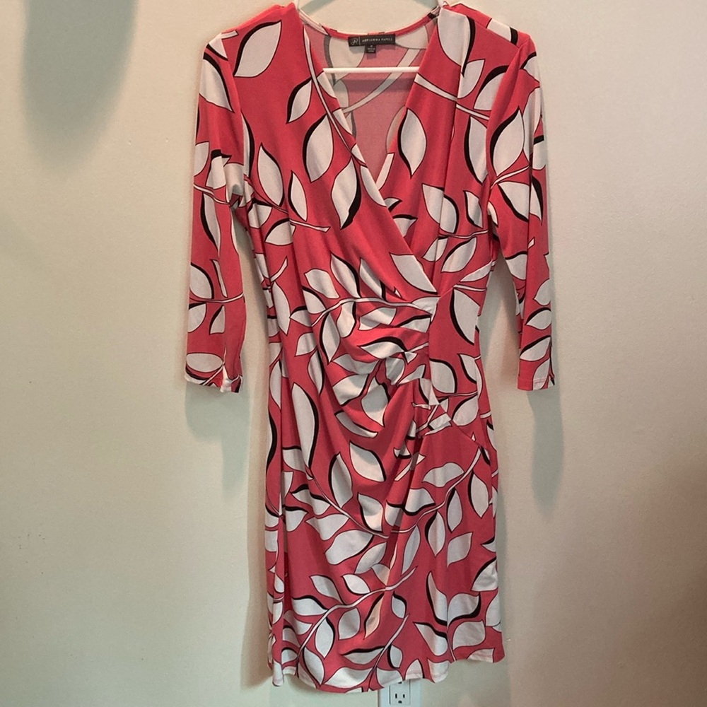 Adrianna Papell leaves coral and white dress.